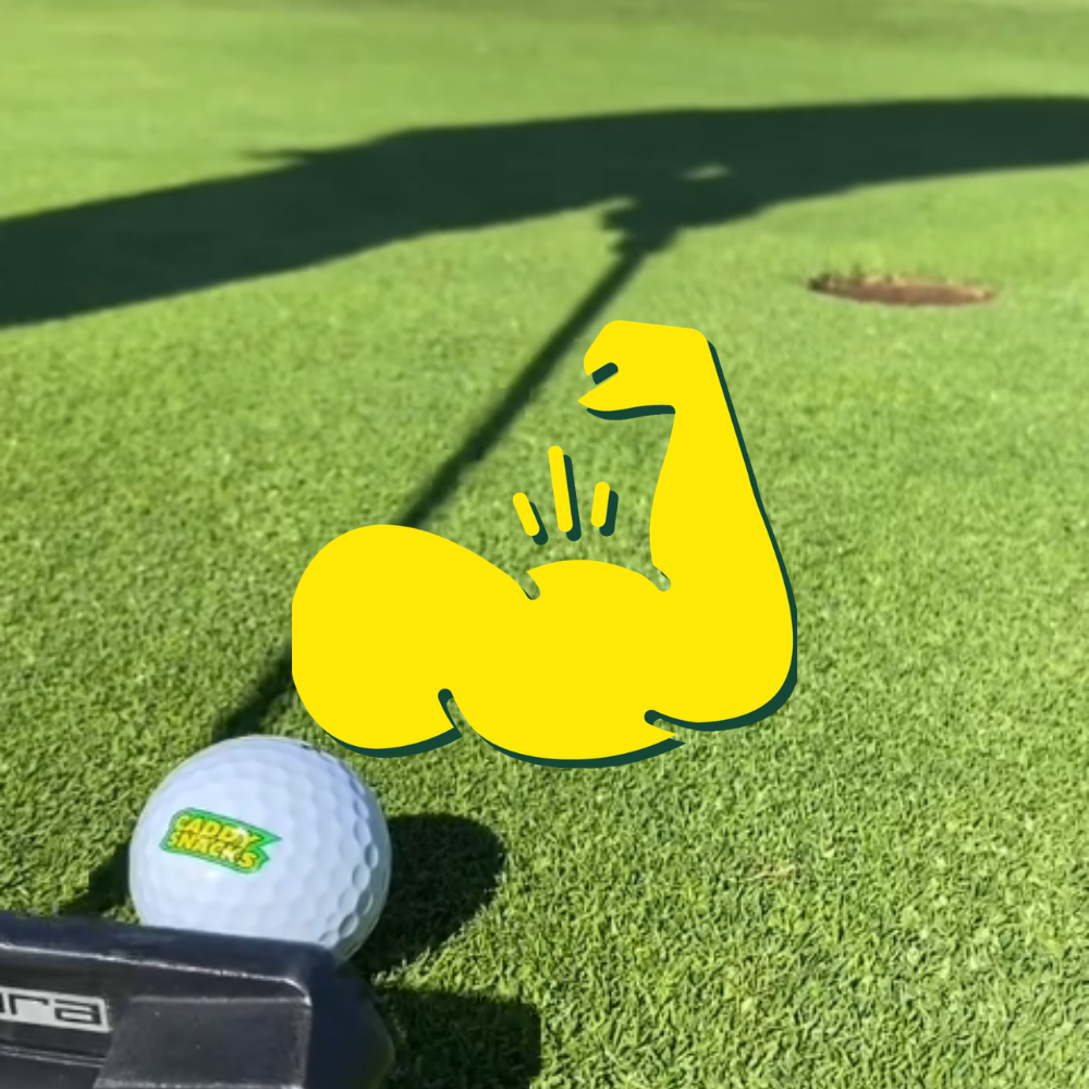 Golf ball with a flexed bicep design on a green golf course