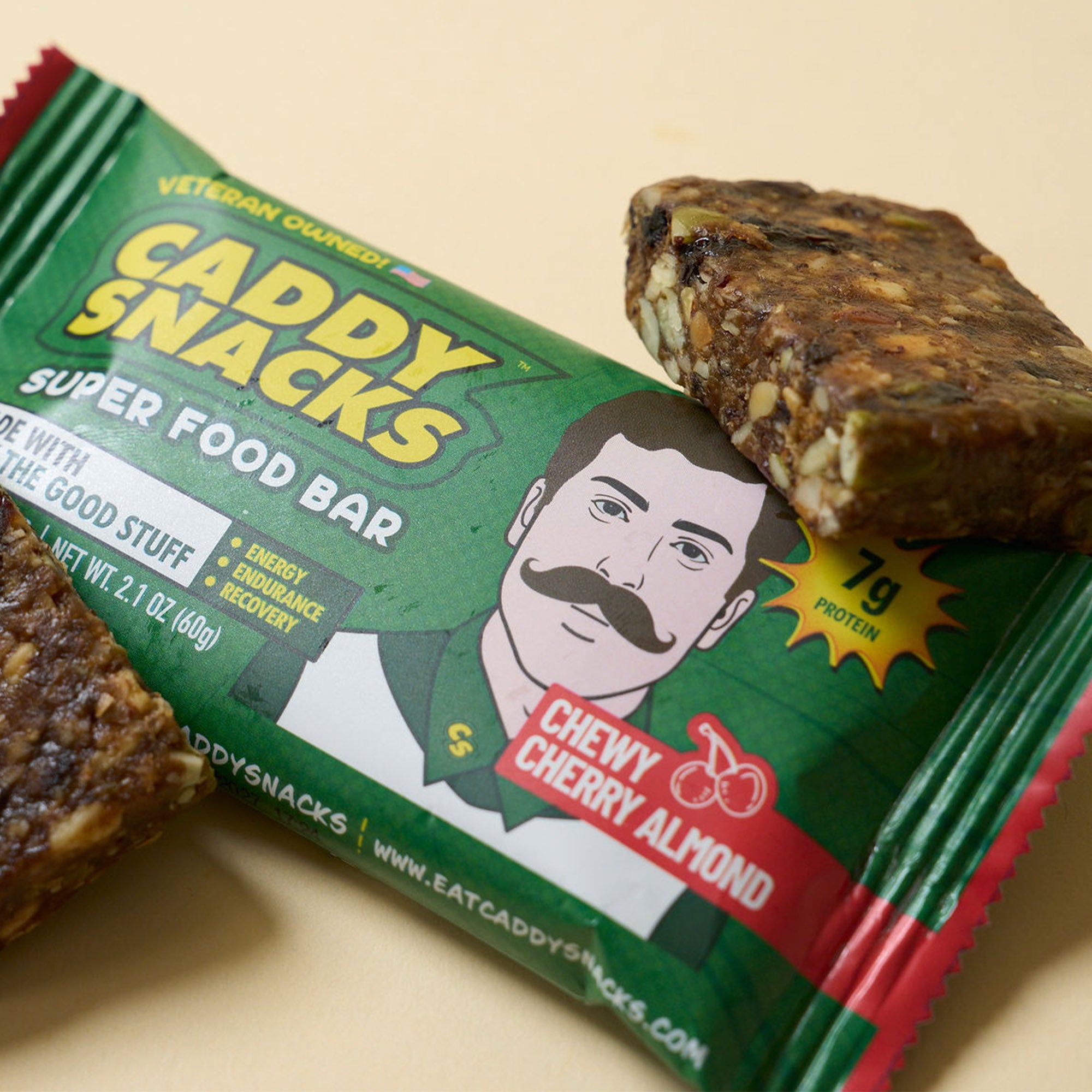 Green super food bar package beside broken bar pieces