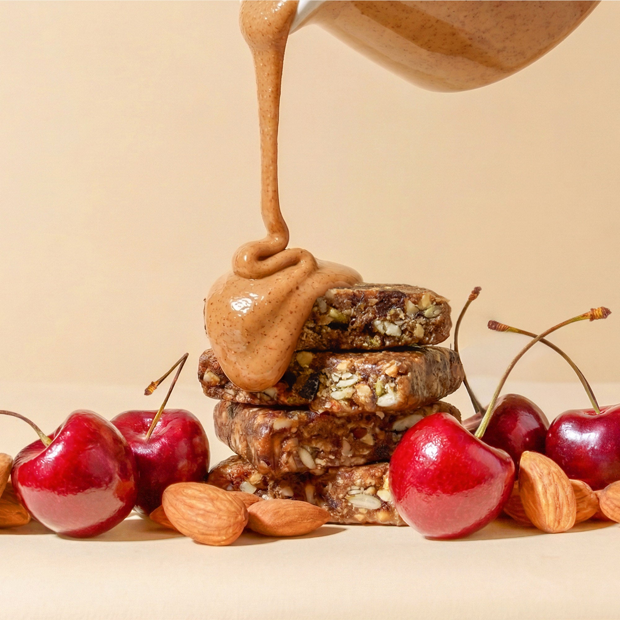Stack of super food bars with caramel drizzle over cherries and almonds
